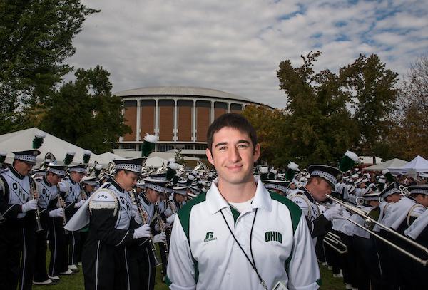 Gary Dillabaugh III poses for a portrait beside the Marching 110 performance during the Miami vs. OU football game tailgate party.  Photo by Elizabeth Held