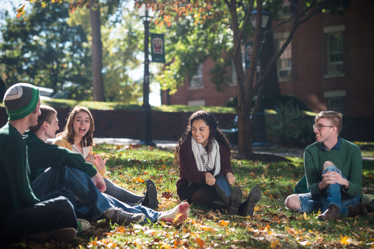 Students sit and talk in College Green