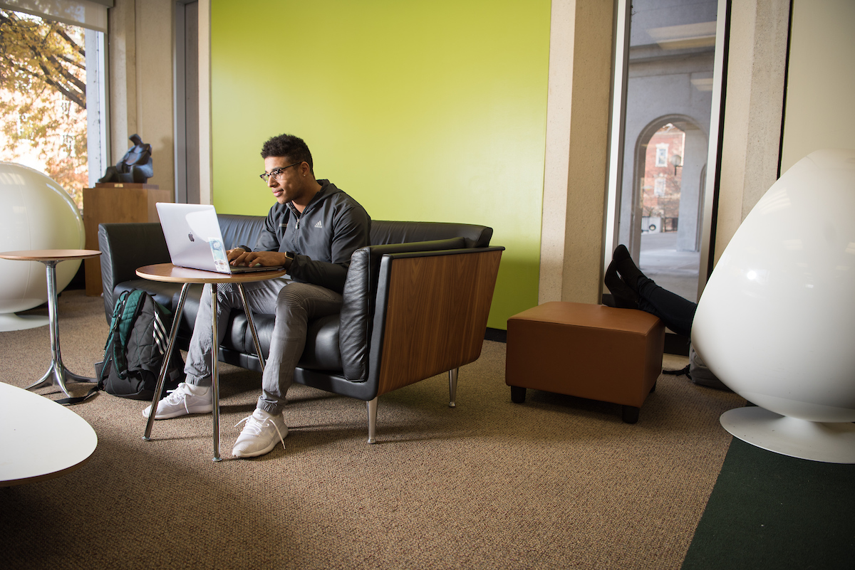 Student types on laptop