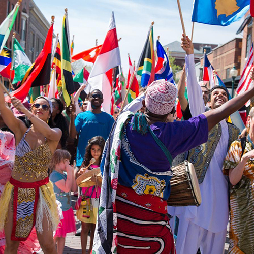 Members of the Ohio University community wave international flags in the global parade